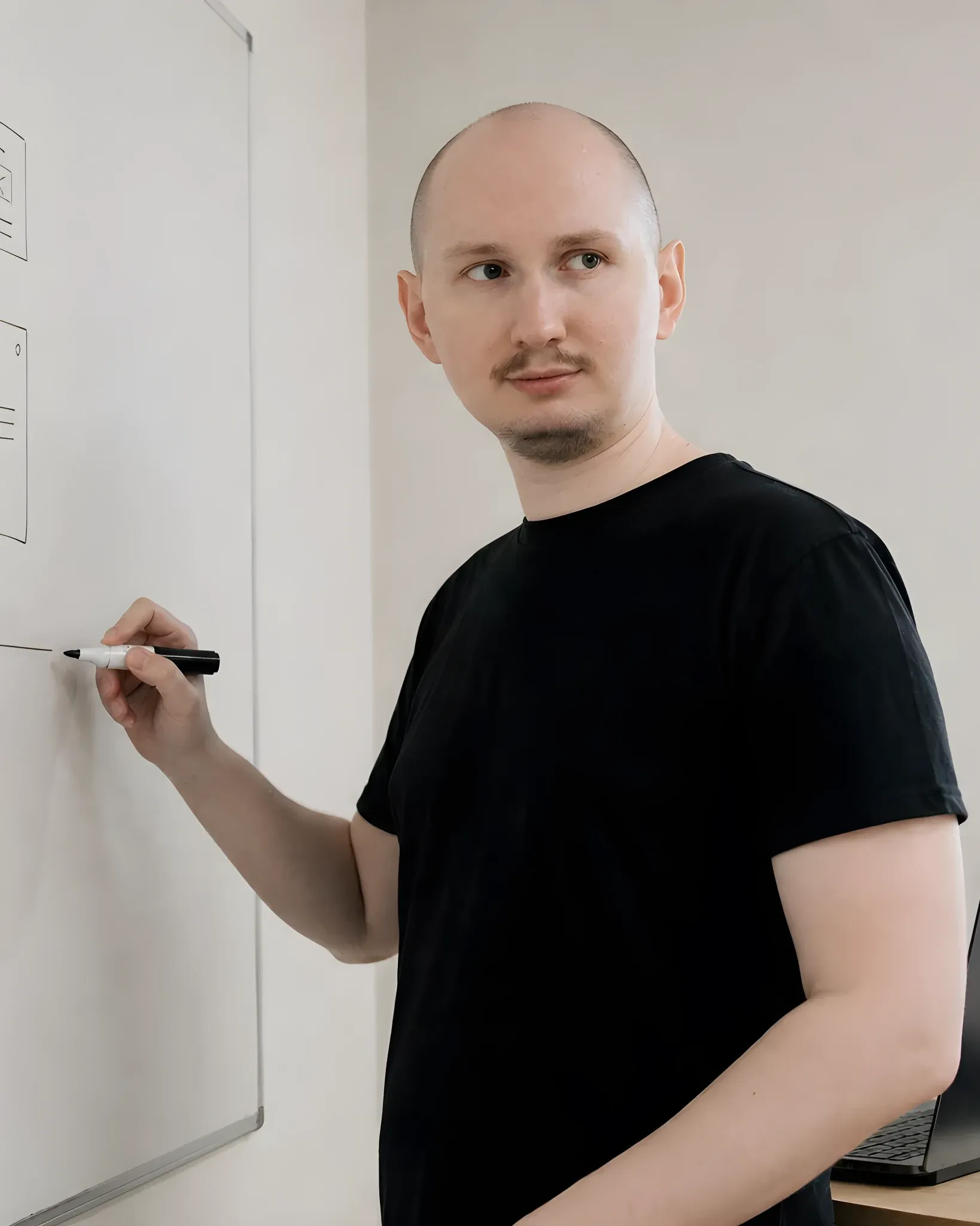 Simon sketching wireframes and a sitemap on a whiteboard