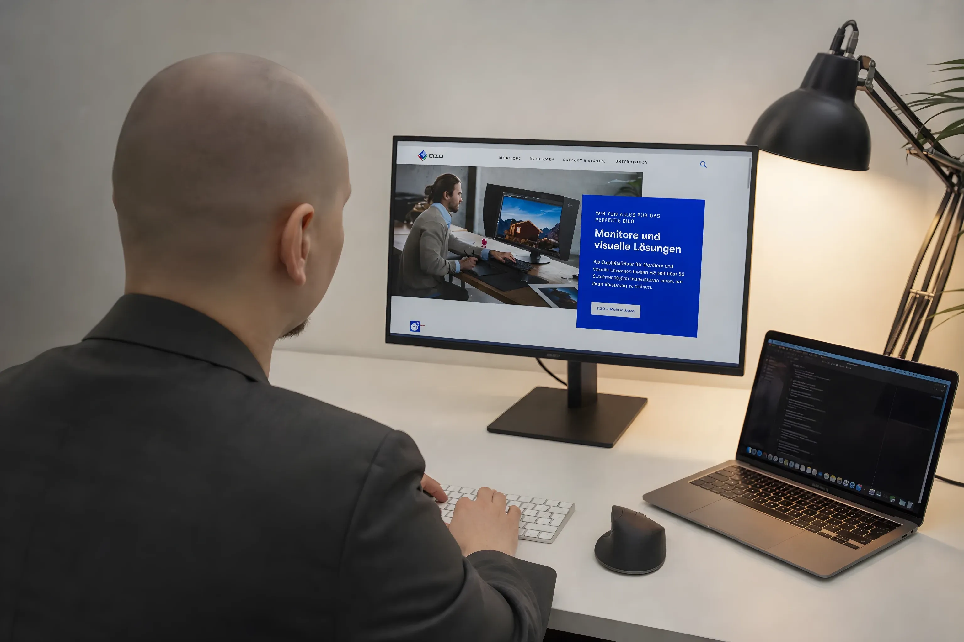 Simon at his desk with the EIZO site on a laptop and an external monitor